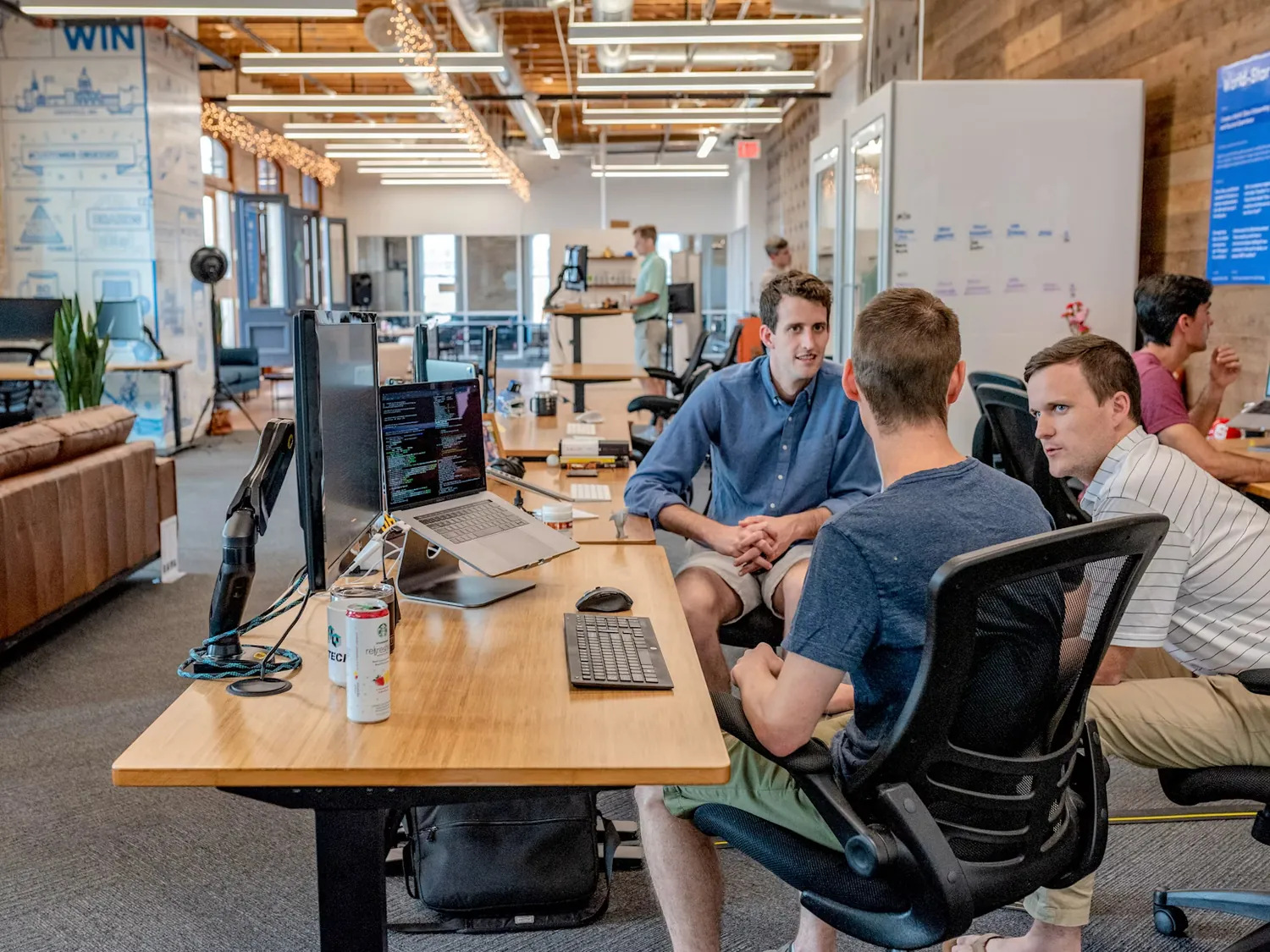 A team of professional designers and coders discussing work.