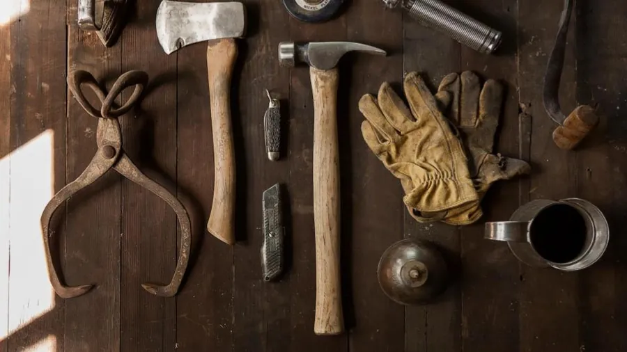 Old hand tools laid out on a wooden workbench